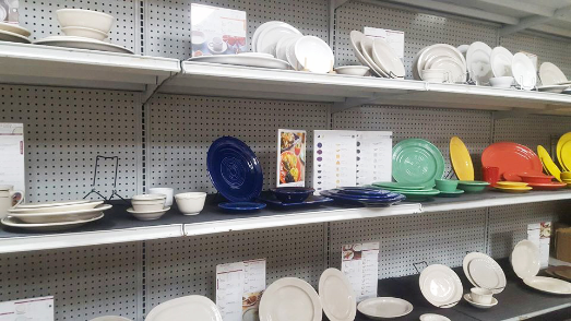 Assortment of plates and bowls on showroom shelves